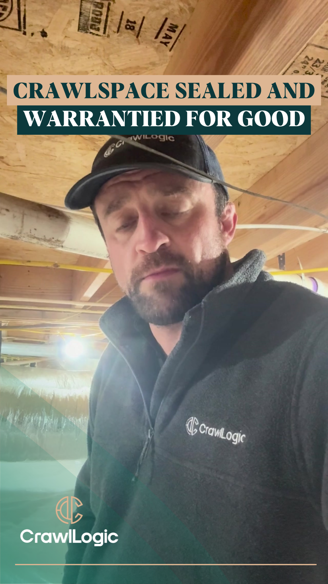 Man in a crawlspace under a home, wearing a cap and jacket. Text:
