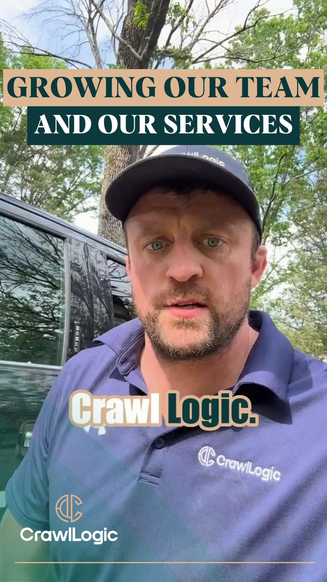 A man in a blue shirt and hat is standing in front of a truck.