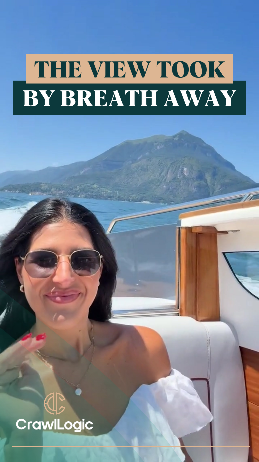 A woman wearing sunglasses is sitting on a boat with a mountain in the background.