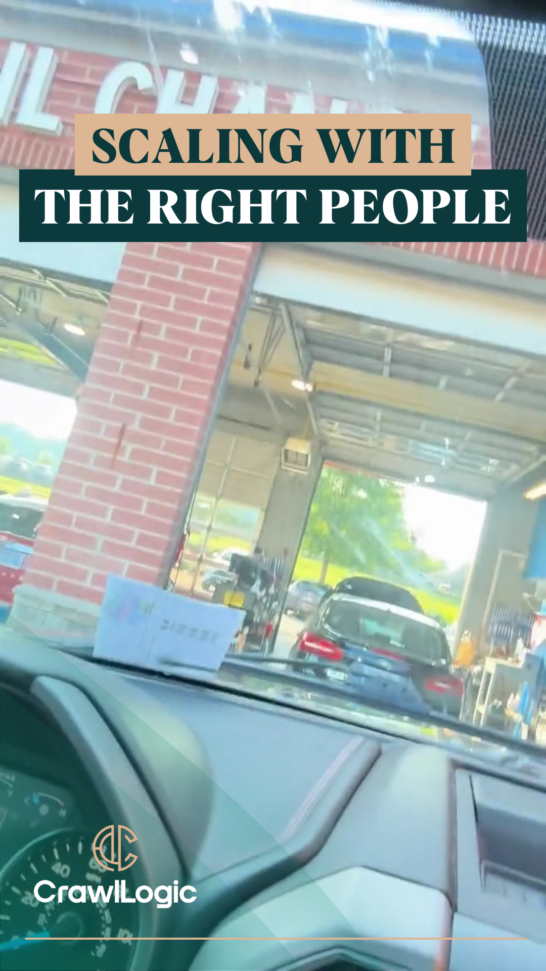 A car is sitting in front of a brick building with a sign that says scaling with the right people