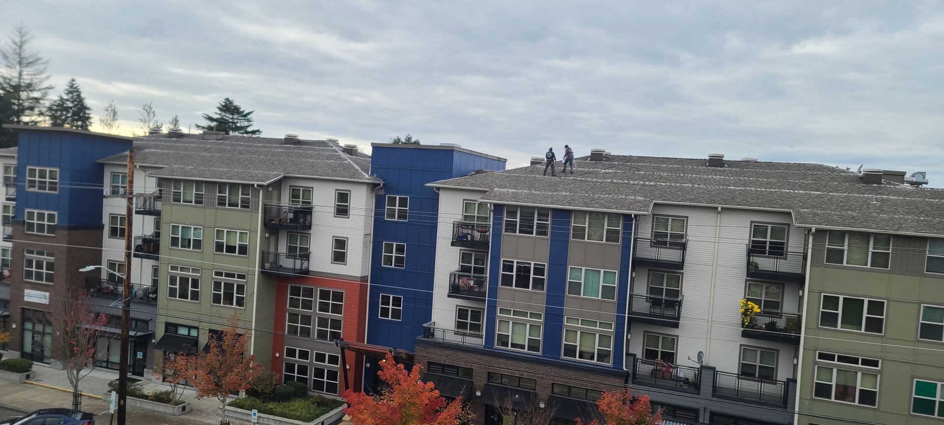 Buildings with varied colors and designs under a cloudy sky.