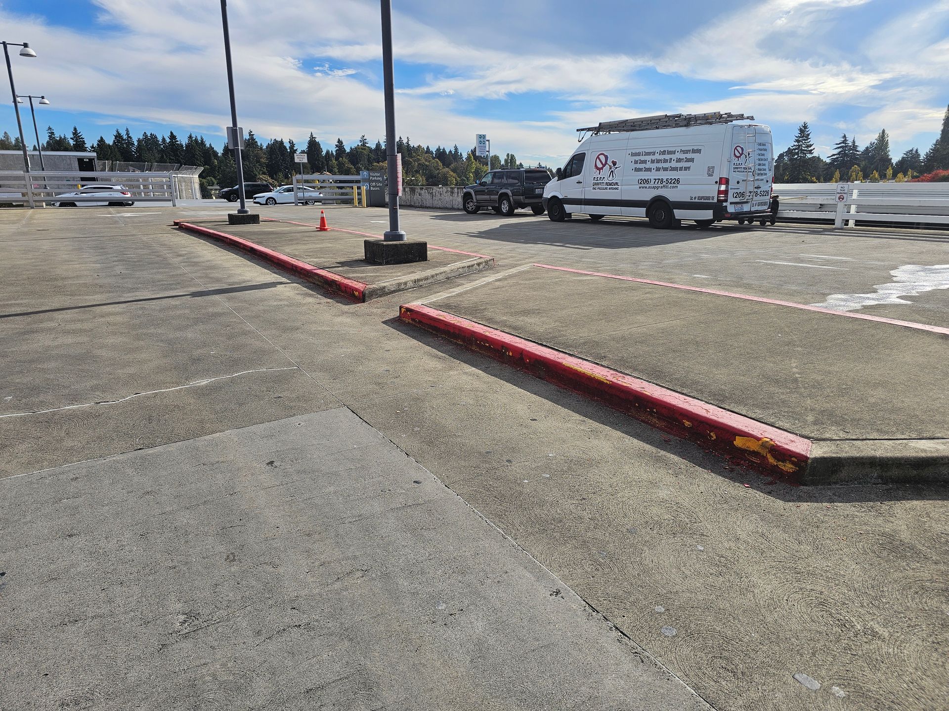 The entrance to the Swedish hospital, seen on a wet day with orange cones, and a coffee shop on the right.