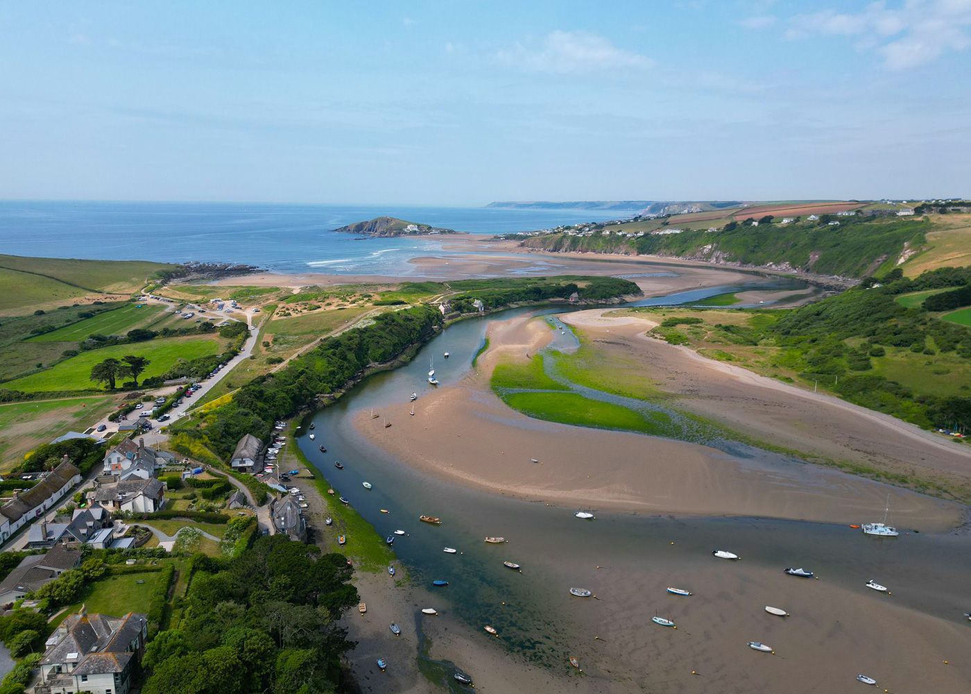 An aerial view of a river flowing into the ocean