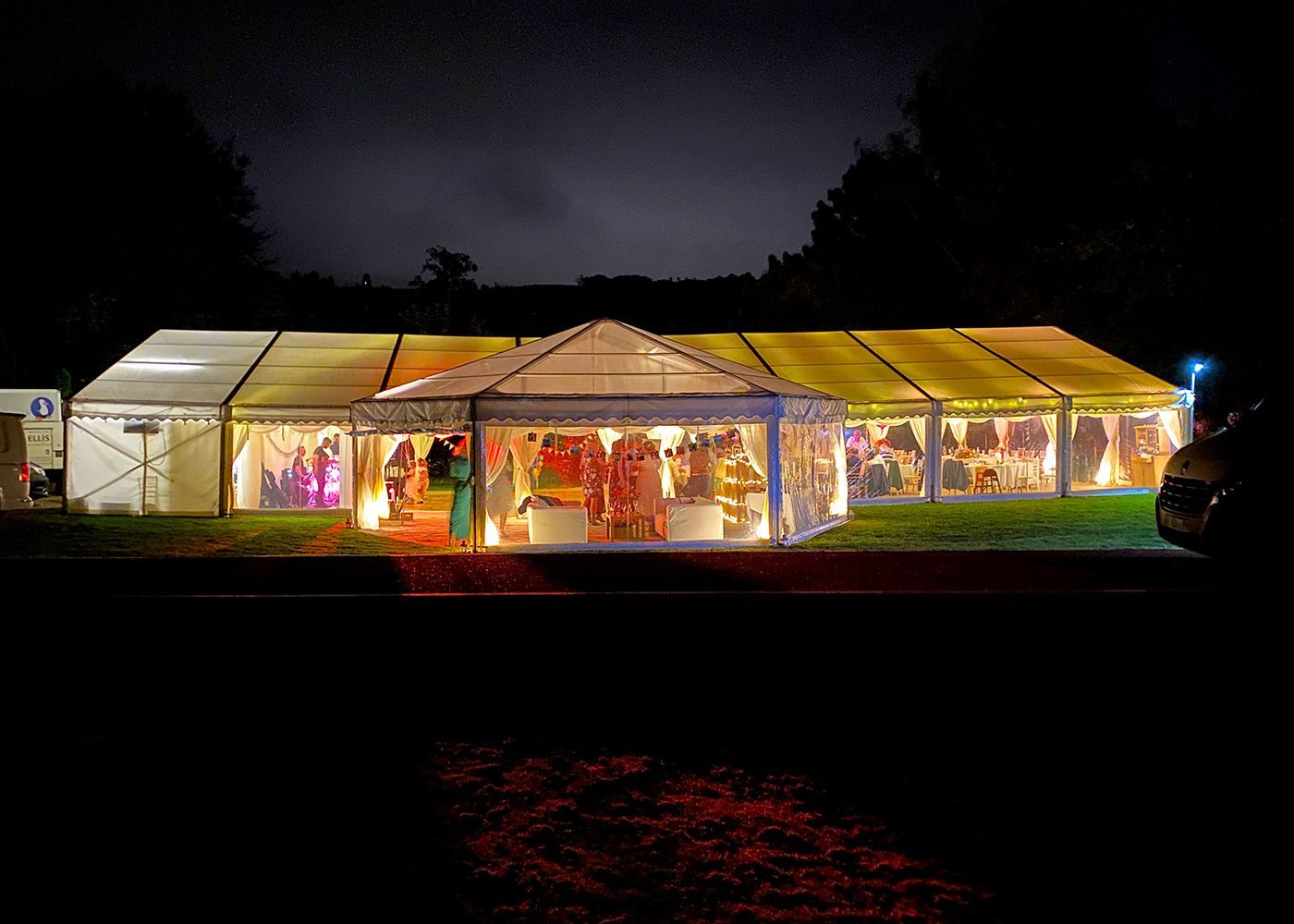 A large tent is lit up at night.