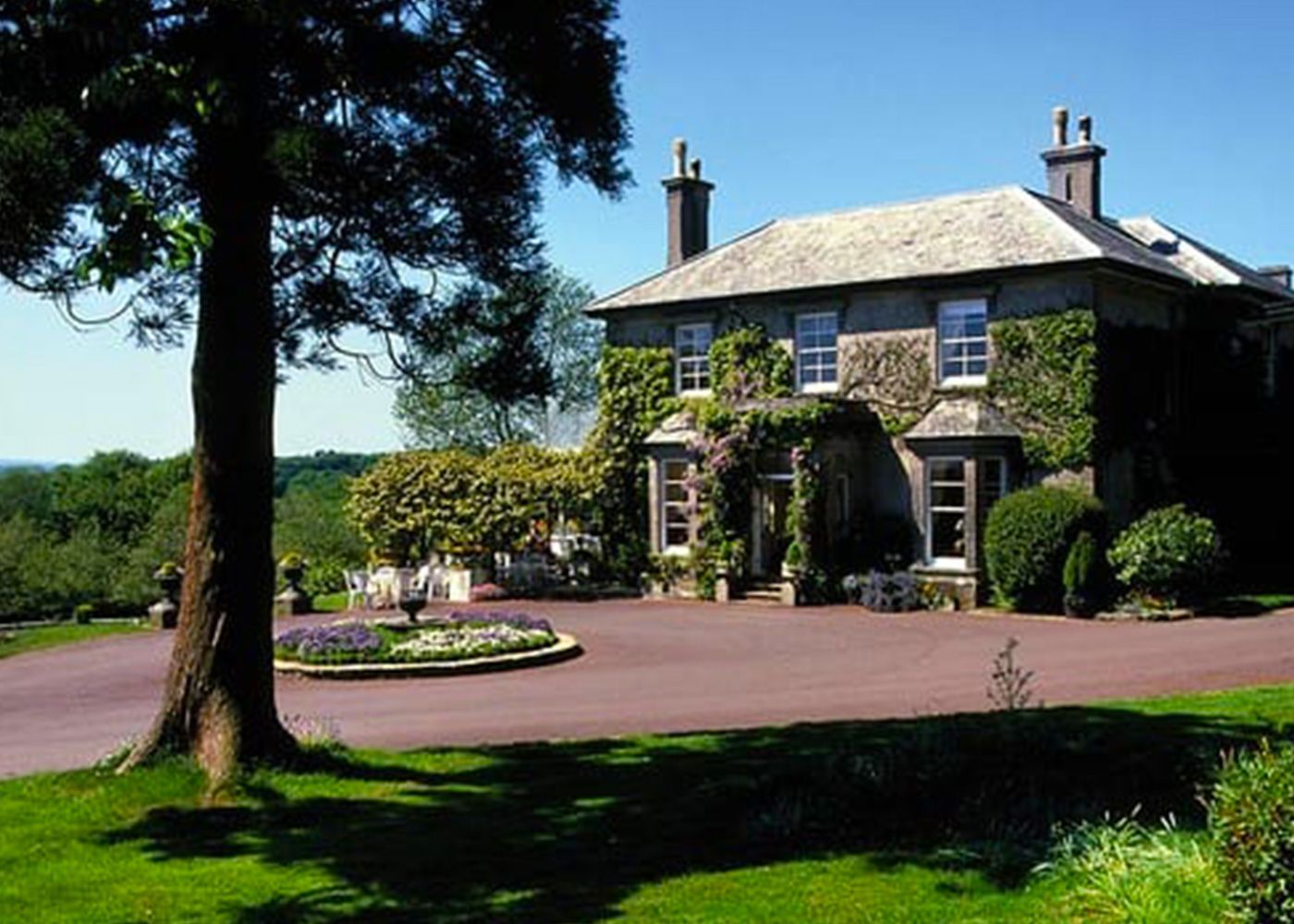 A large house with a tree in front of it
