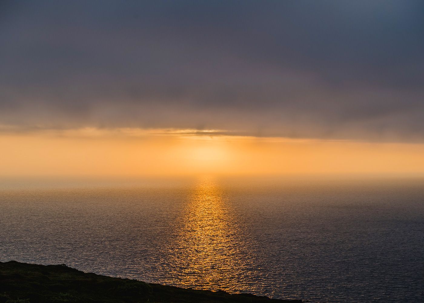 The sun is setting over the ocean.