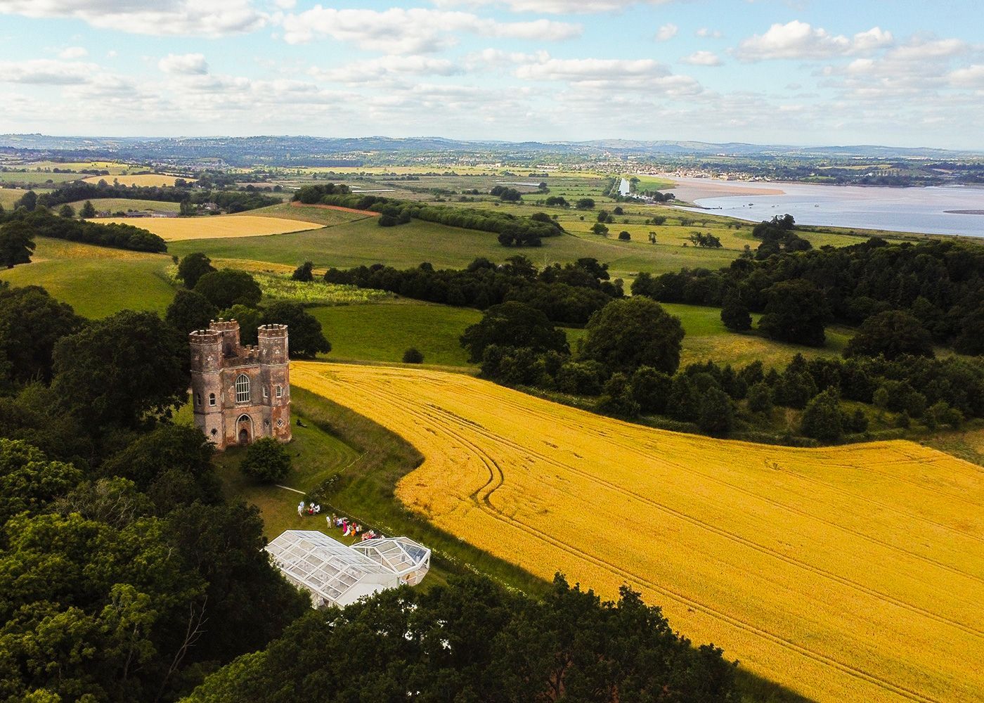 An aerial view of a castle in the middle of a field.