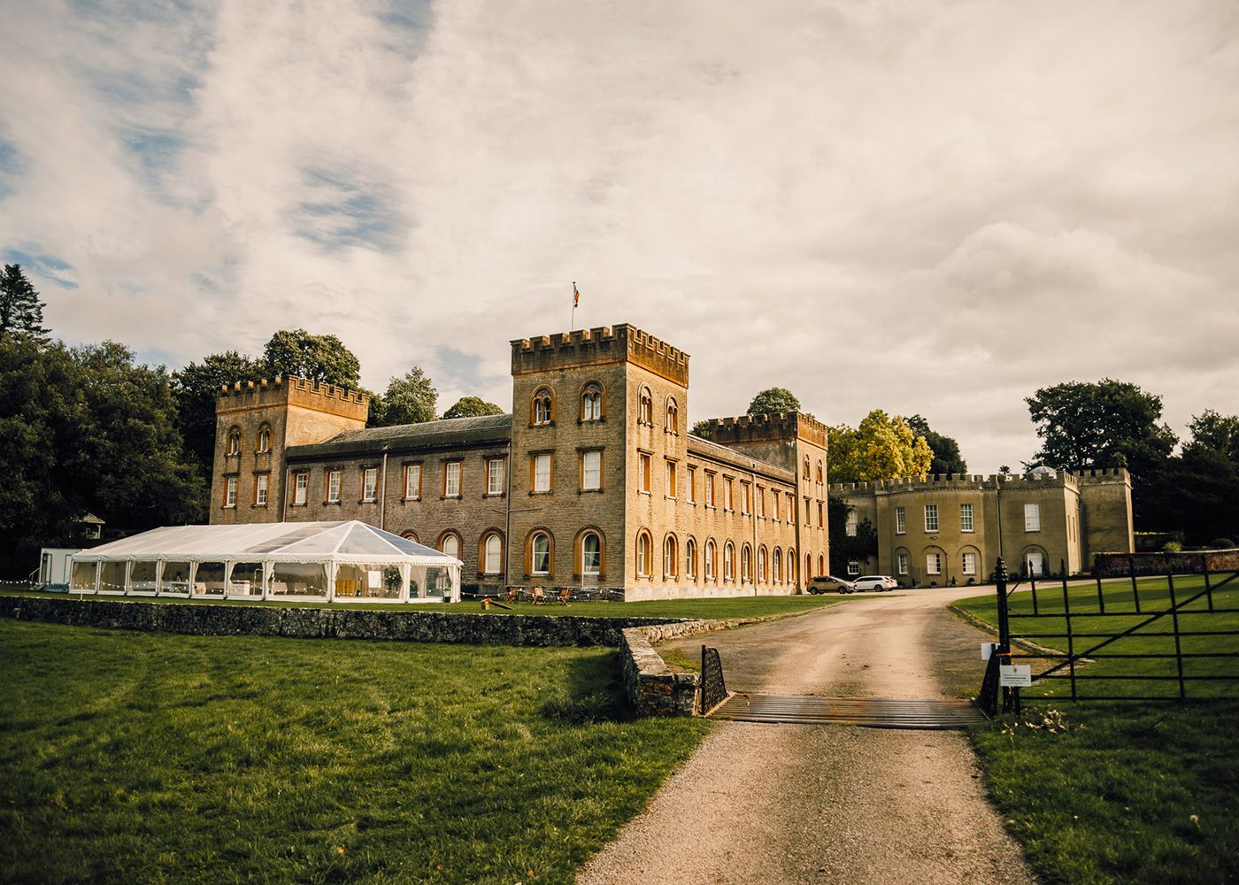 A large castle with a clear tent in front of it.