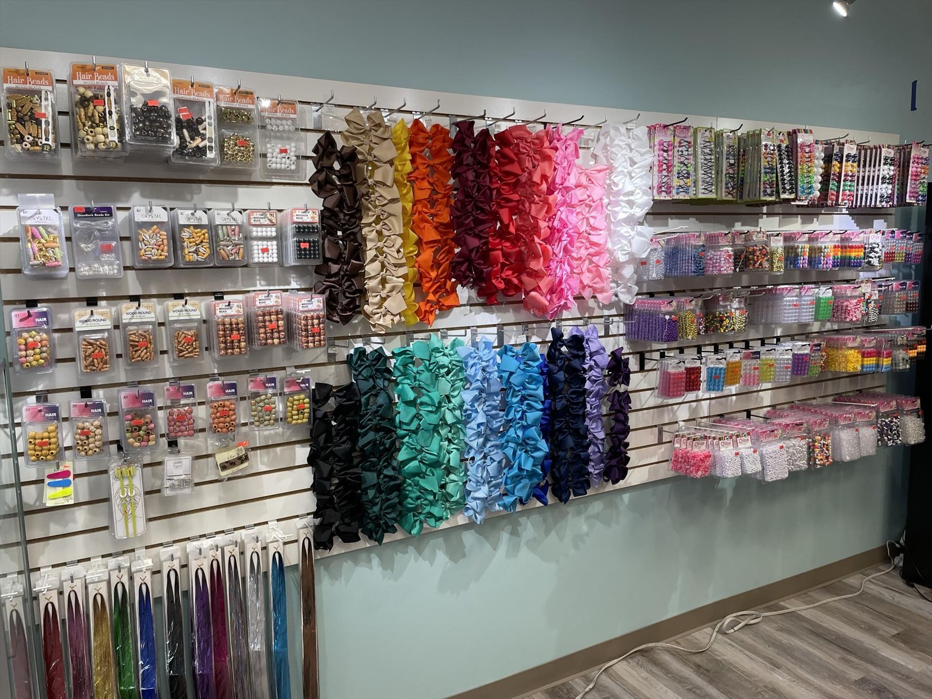 Wall display of hair accessories in various colors and styles.