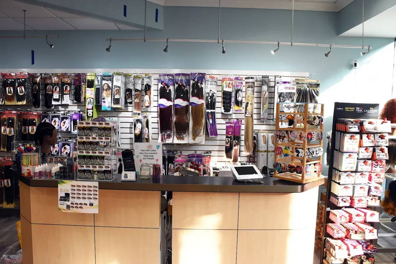 Hair supply store interior with wigs, hair extensions, and retail displays.