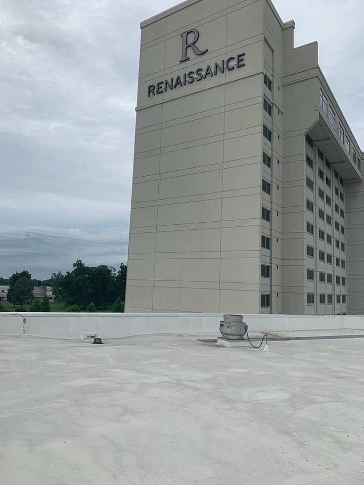 View from a flat roof, Renaissance hotel exterior with cloudy sky background.