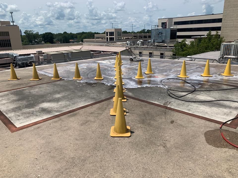 Yellow traffic cones on a rooftop, possibly indicating a wet surface or work area.