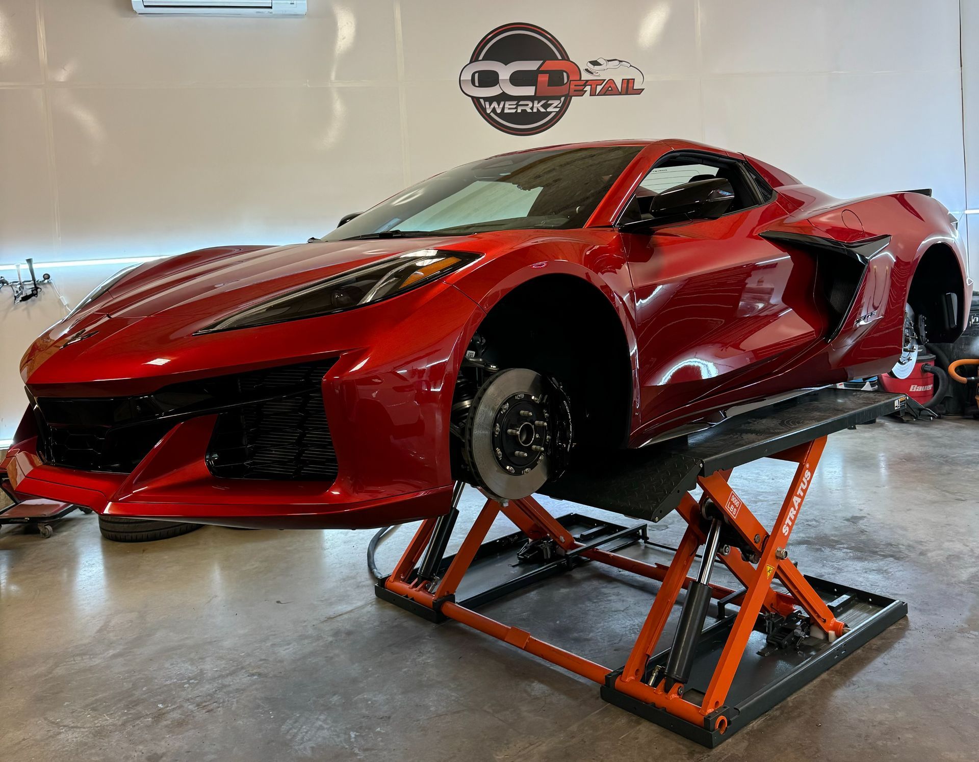 A red convertible chevrolet camaro is parked on the side of the road.