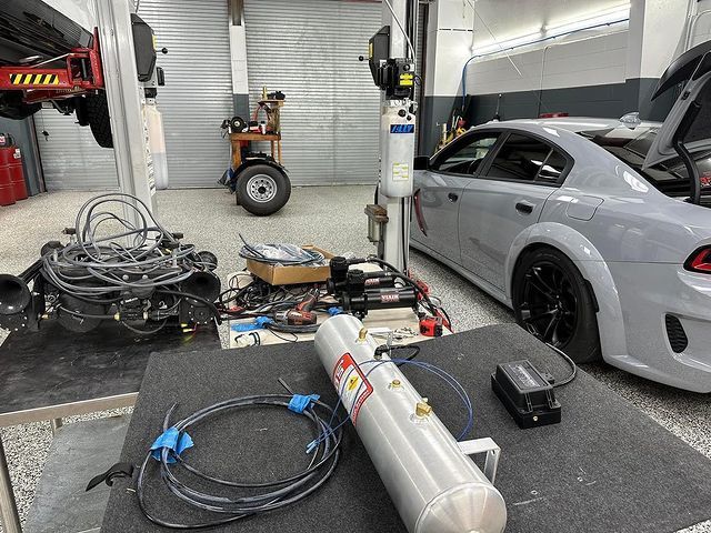 A car is being worked on in a garage.