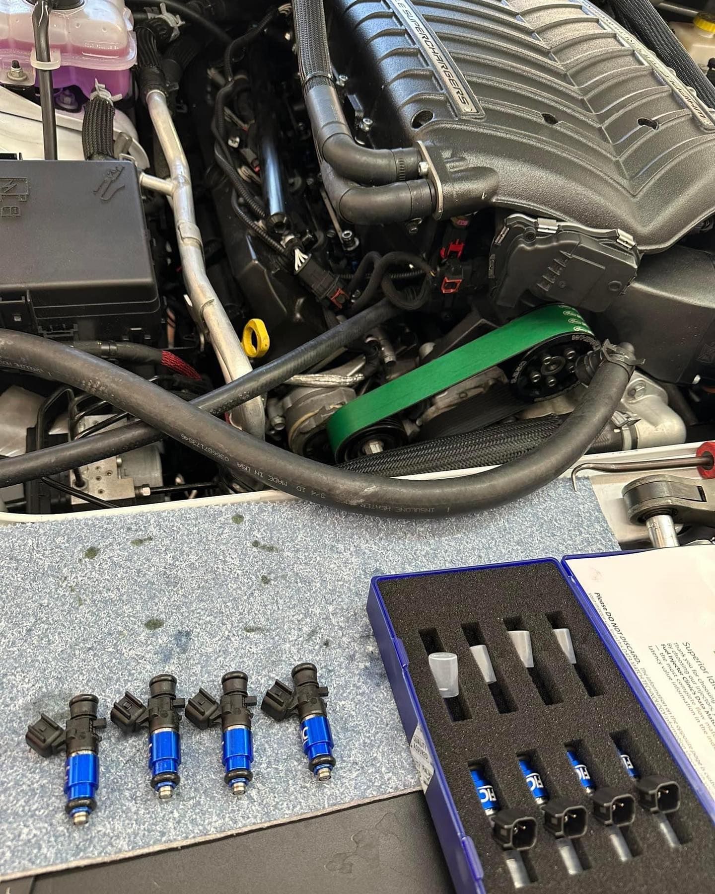 A car engine is being worked on in a garage.
