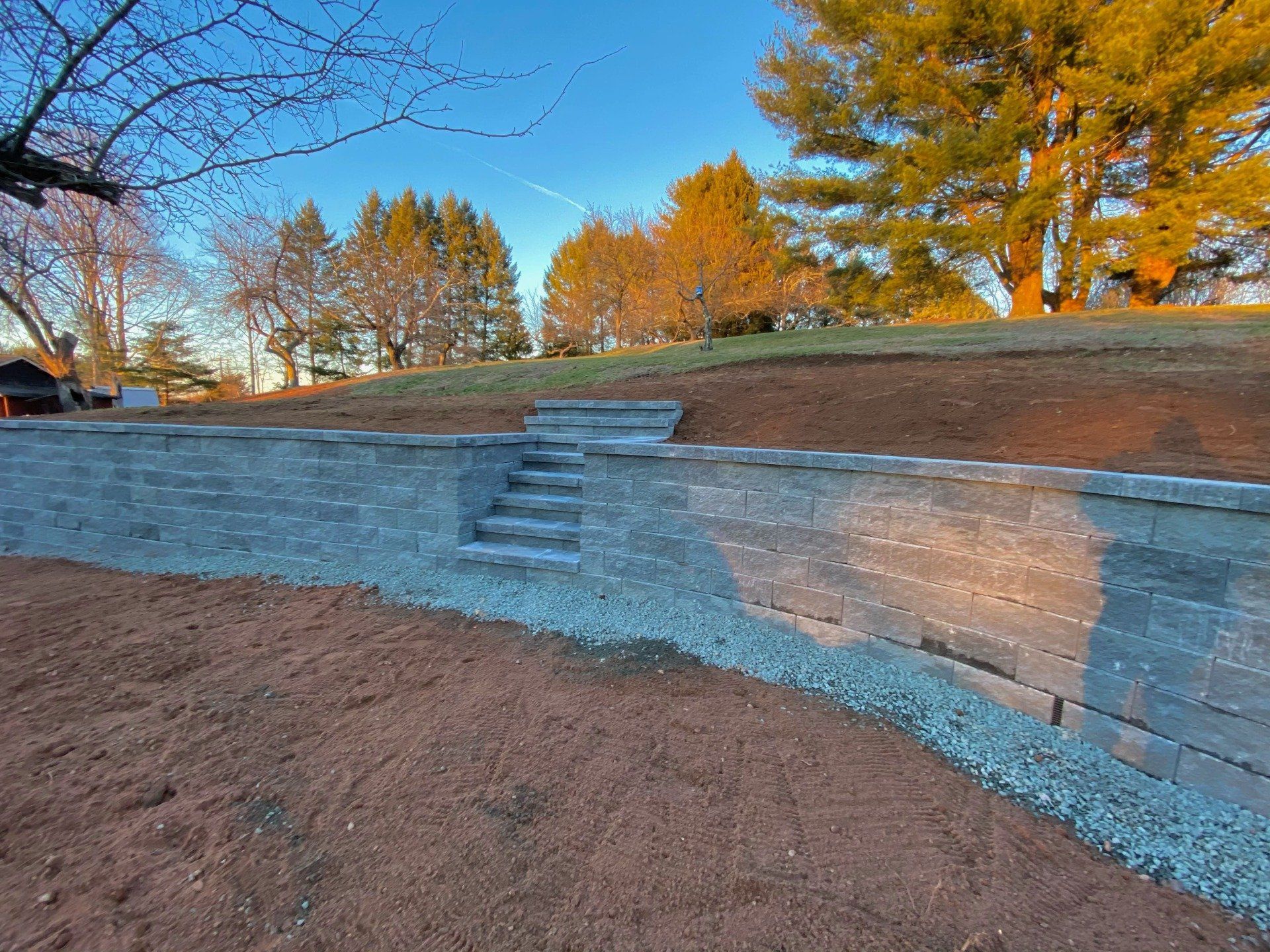 Stone patio with outdoor kitchen and fire pit in Ellington CT