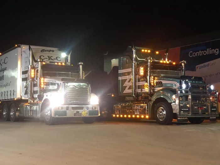 Two trucks with light on at night — About CKC Haulage in Townsville, QLD