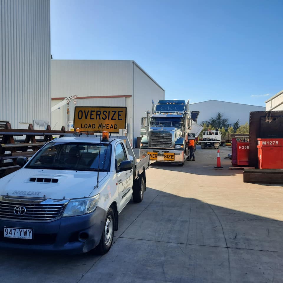 Truck Carrying Over Size Load with Support Vehicle — Bulk Haulage in Townsville, QLD