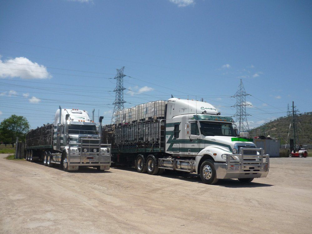 Two White Heavy Truck On The Parking Lot — Transport Company in Townsville, QLD