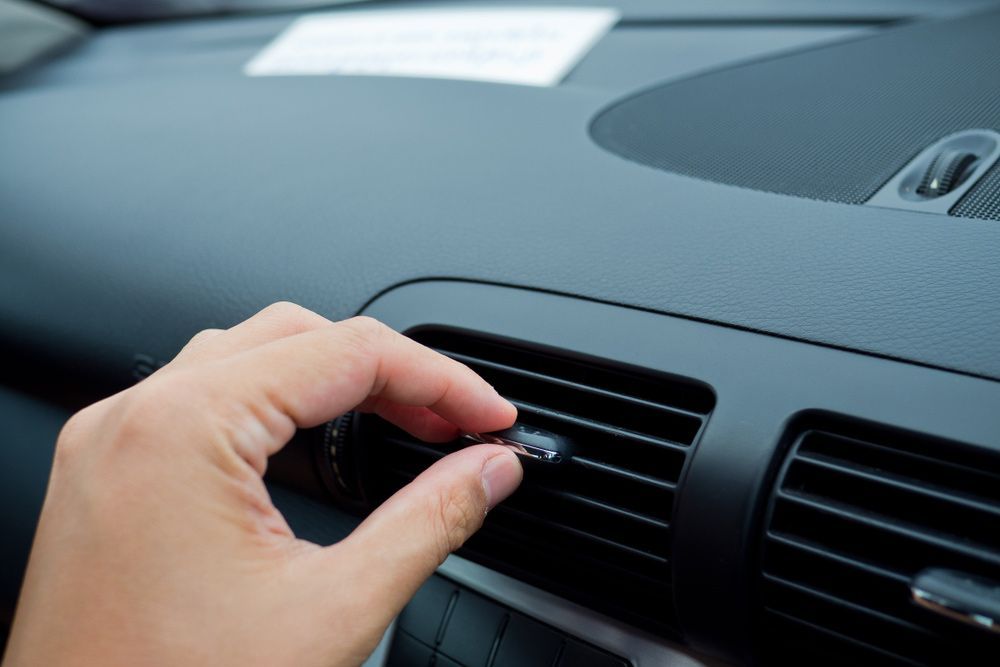 Person Adjusting The Air Vent In A Car Air Conditioner — Erina Car Air Conditioning In Wyoming, NSW