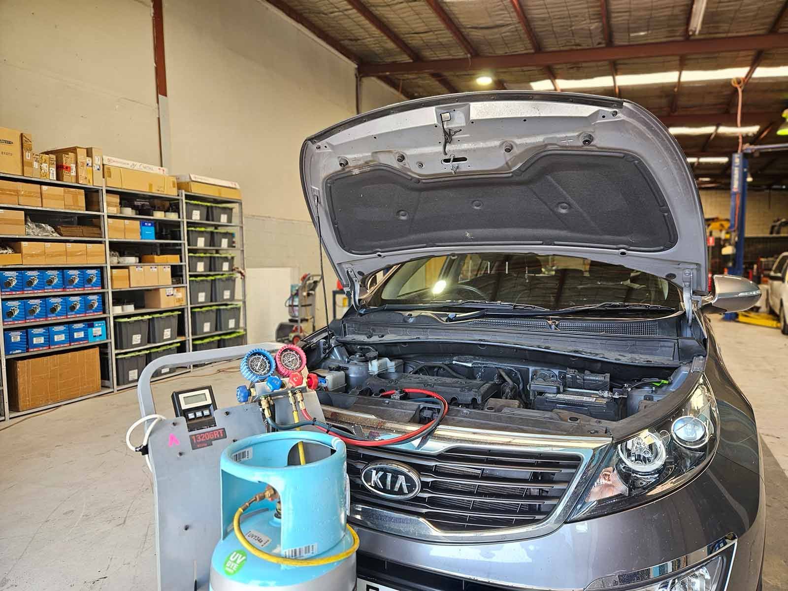 Car Serviced In A Garage With The Hood Up — Erina Car Air Conditioning In Erina, NSW