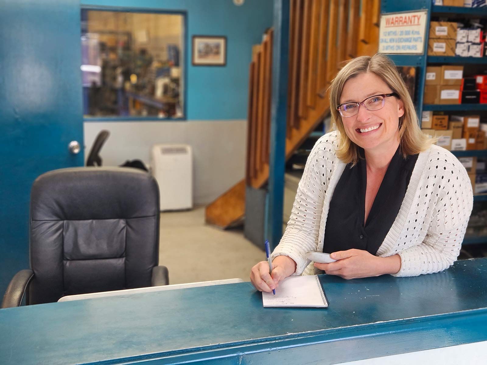 Woman At A Desk With A Pen In Her Hand — Erina Car Air Conditioning In Erina, NSW