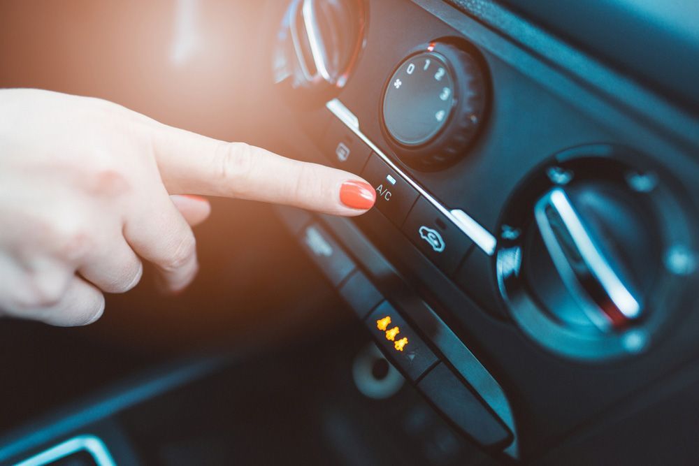 Woman Adjusting The Air Conditioning In Her Car — Erina Car Air Conditioning In Erina, NSW