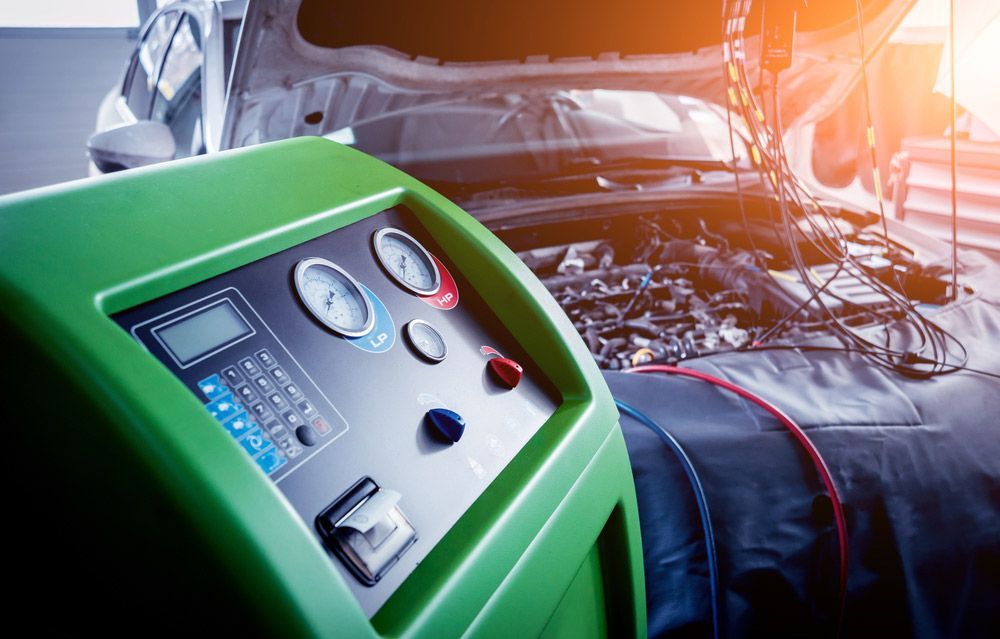 Green Machine Sitting Under The Hood Of A Car — Erina Car Air Conditioning In Kincumber, NSW