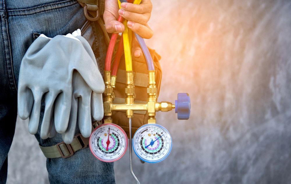 Car Technician With A Pair Of Gauges And A Pair Of Gloves — Erina Car Air Conditioning In Terrigal, NSW