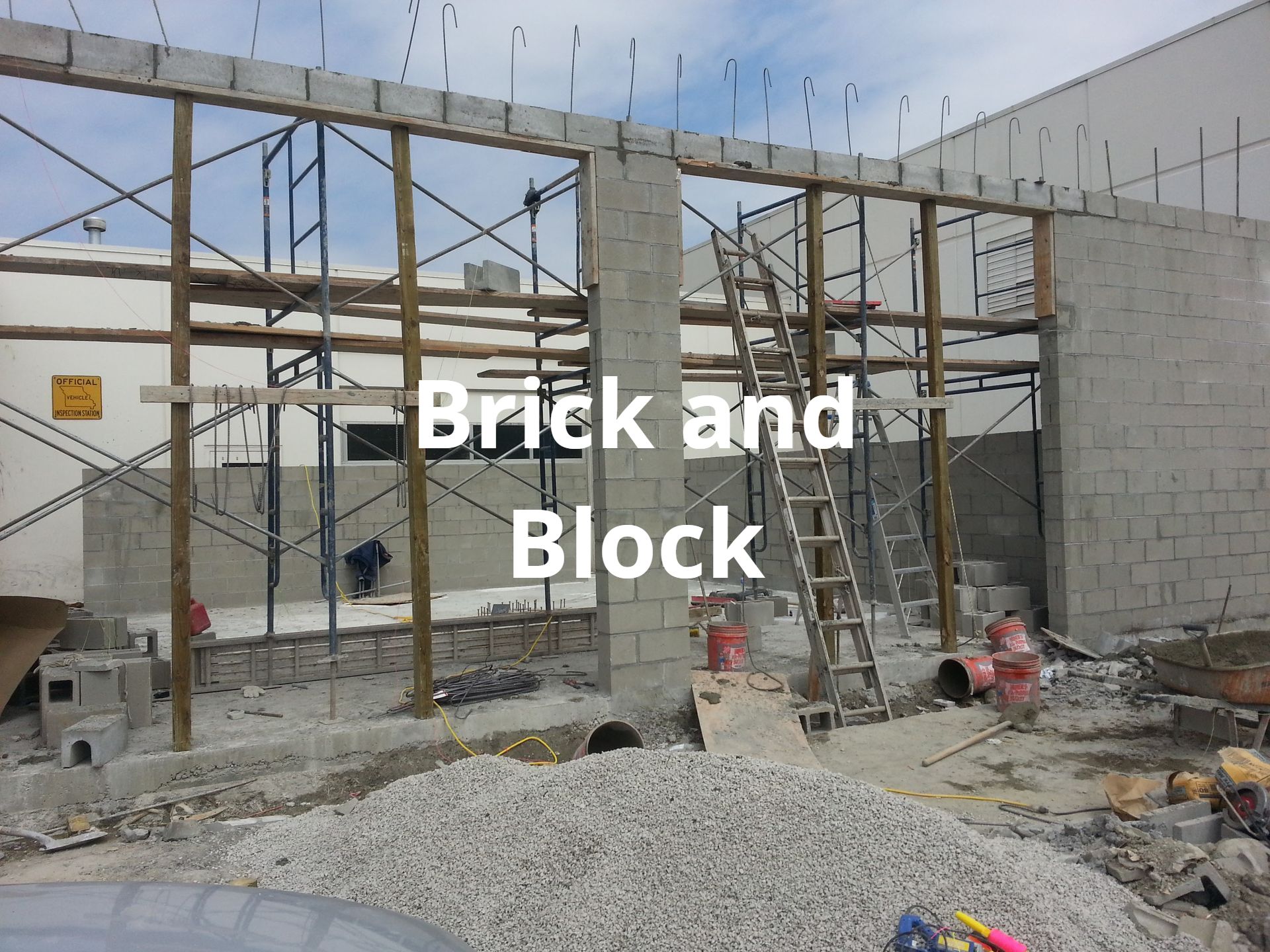 A brick and block building under construction with scaffolding