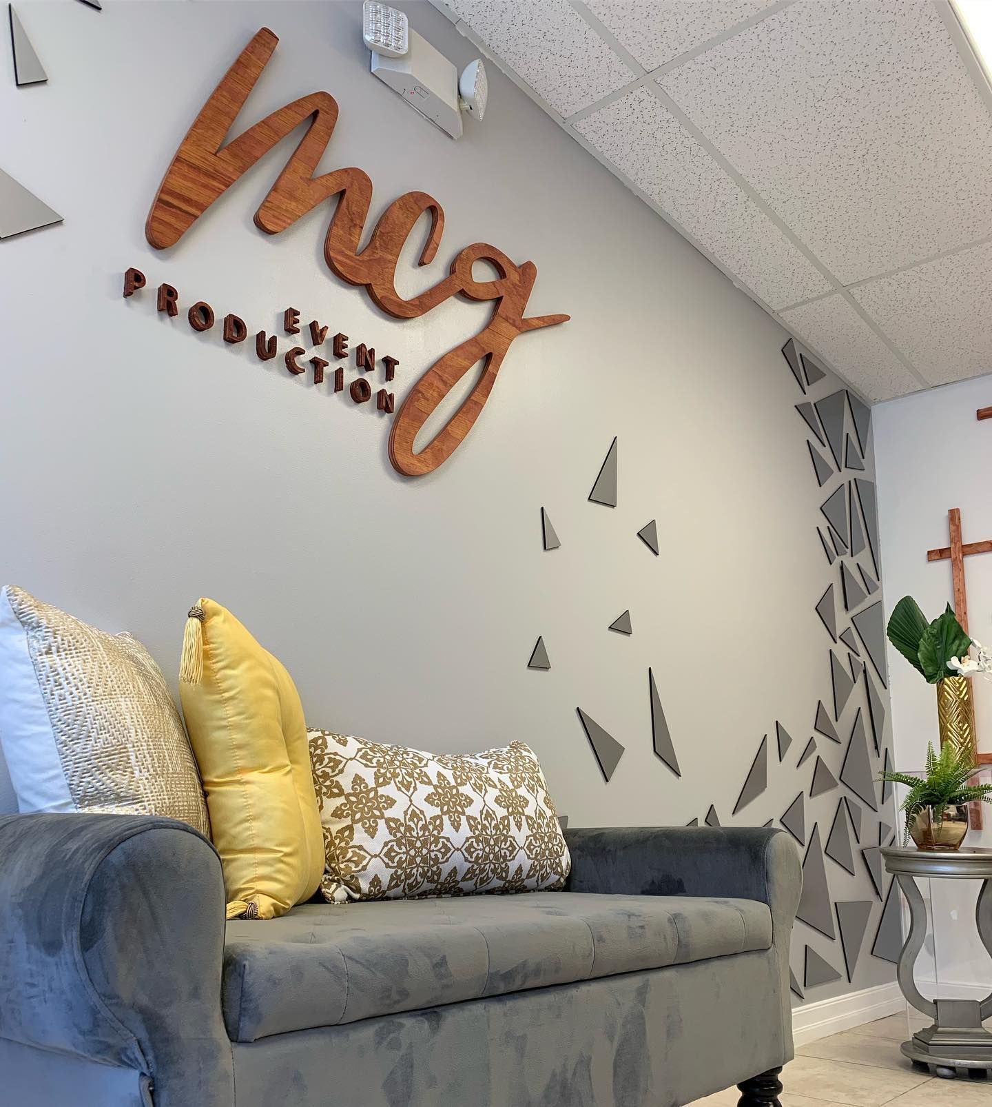 A couch in front of a wall that says meg production