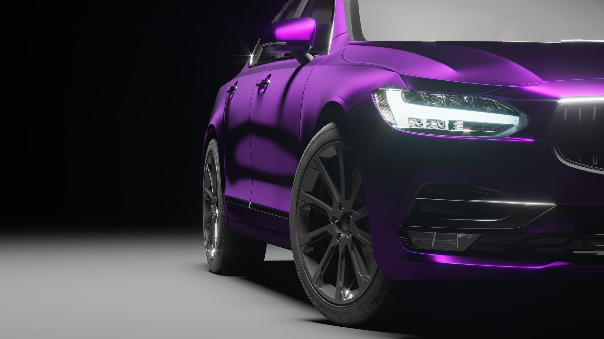 A close up of a purple car with a black background.