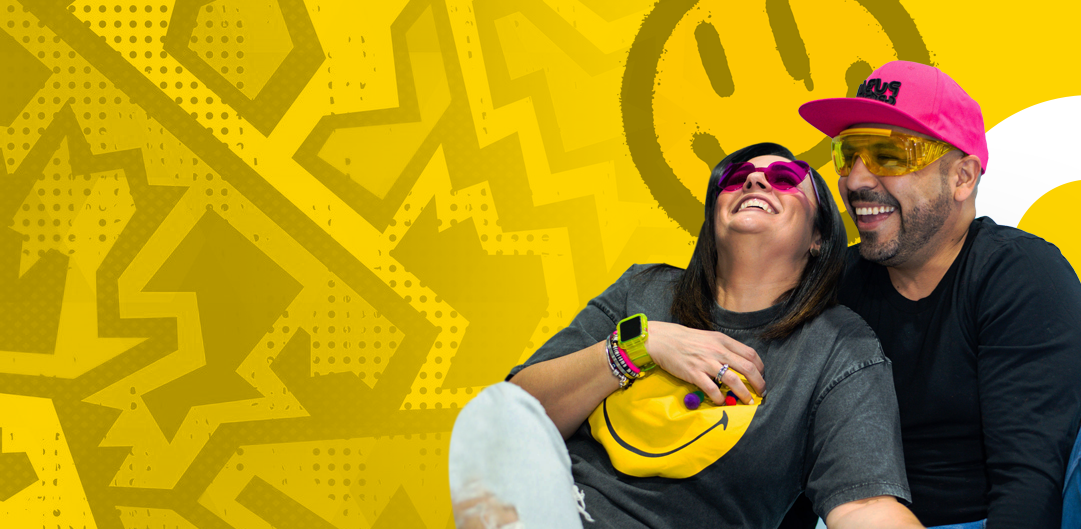 A man and a woman are sitting next to each other on a yellow background.