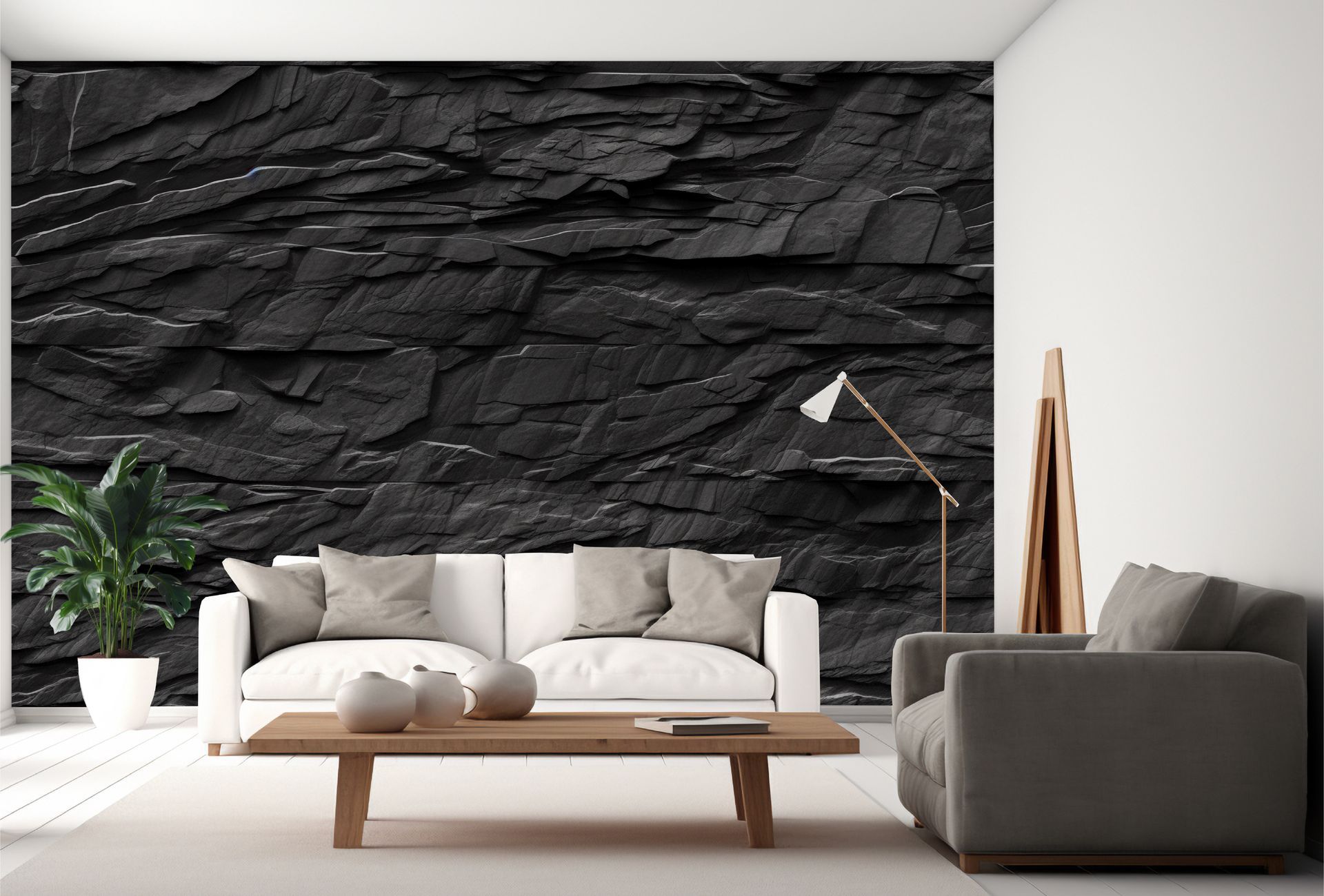 A living room with a couch , chair , coffee table and a black stone wall.