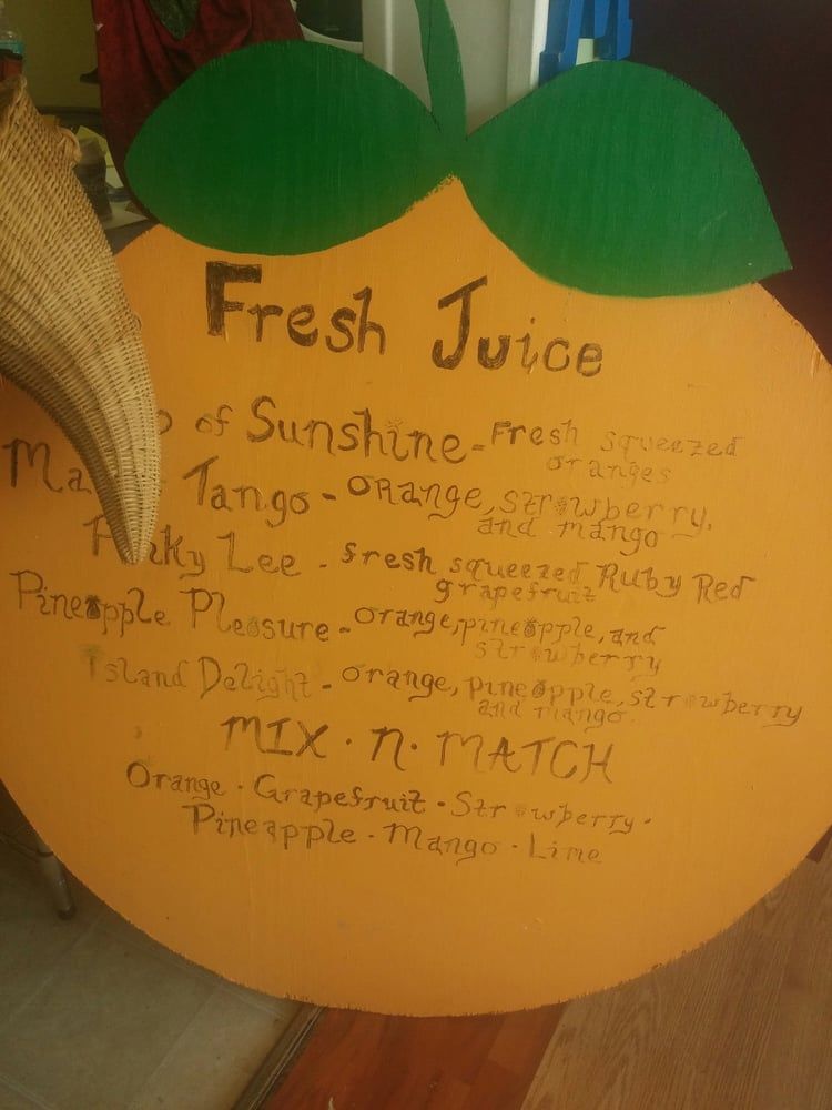 Orange juice menu with handwritten flavors, a large orange shape.