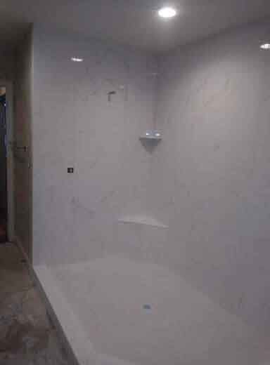 A bathroom with a bathtub and a shower stall.