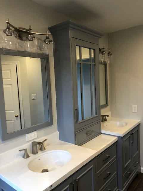 A bathroom with two sinks and two mirrors.