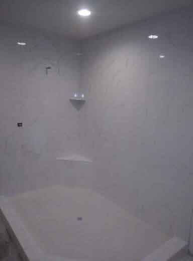 A bathroom with a bathtub and a shower stall.