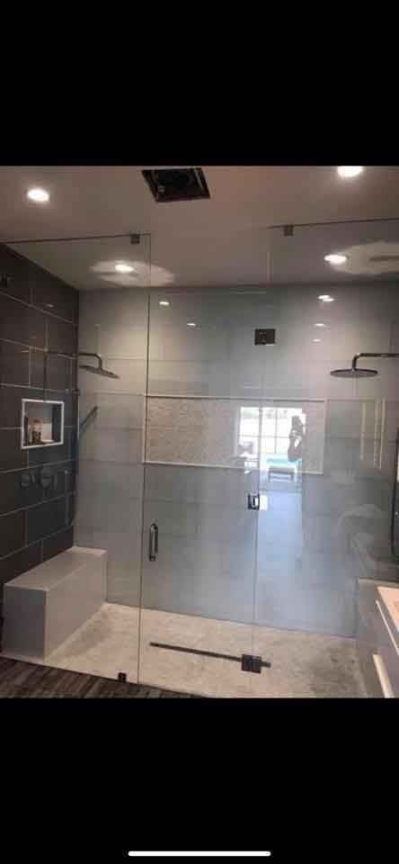 A bathroom with a walk in shower and a bathtub.