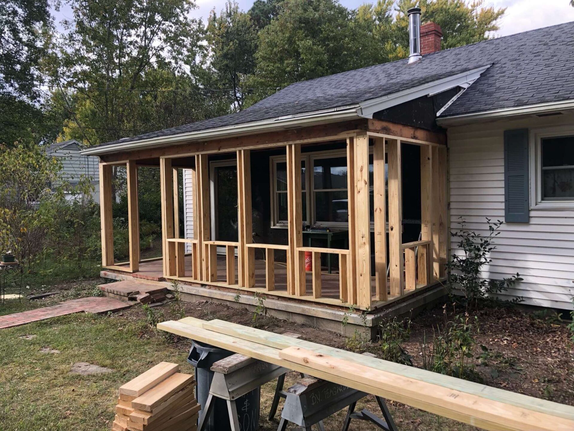 A porch is being built on the side of a house.