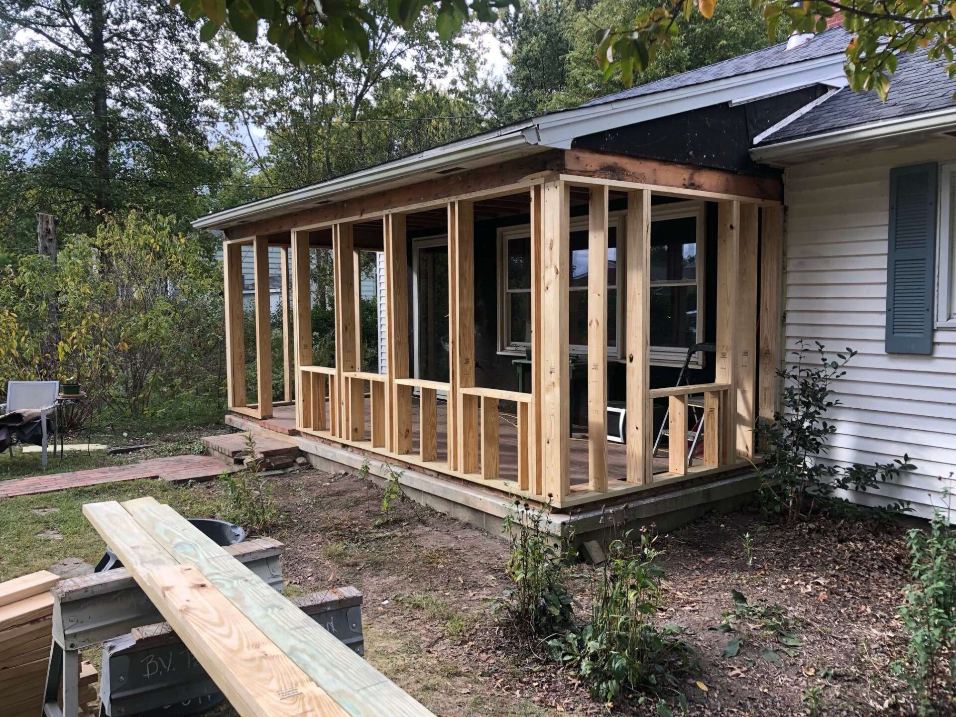 A porch is being built on the side of a house.