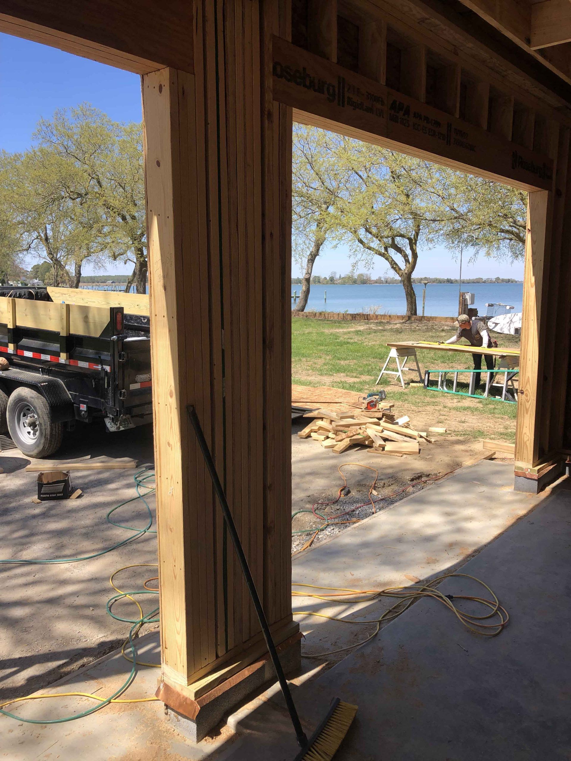 A truck is parked in front of a building under construction.