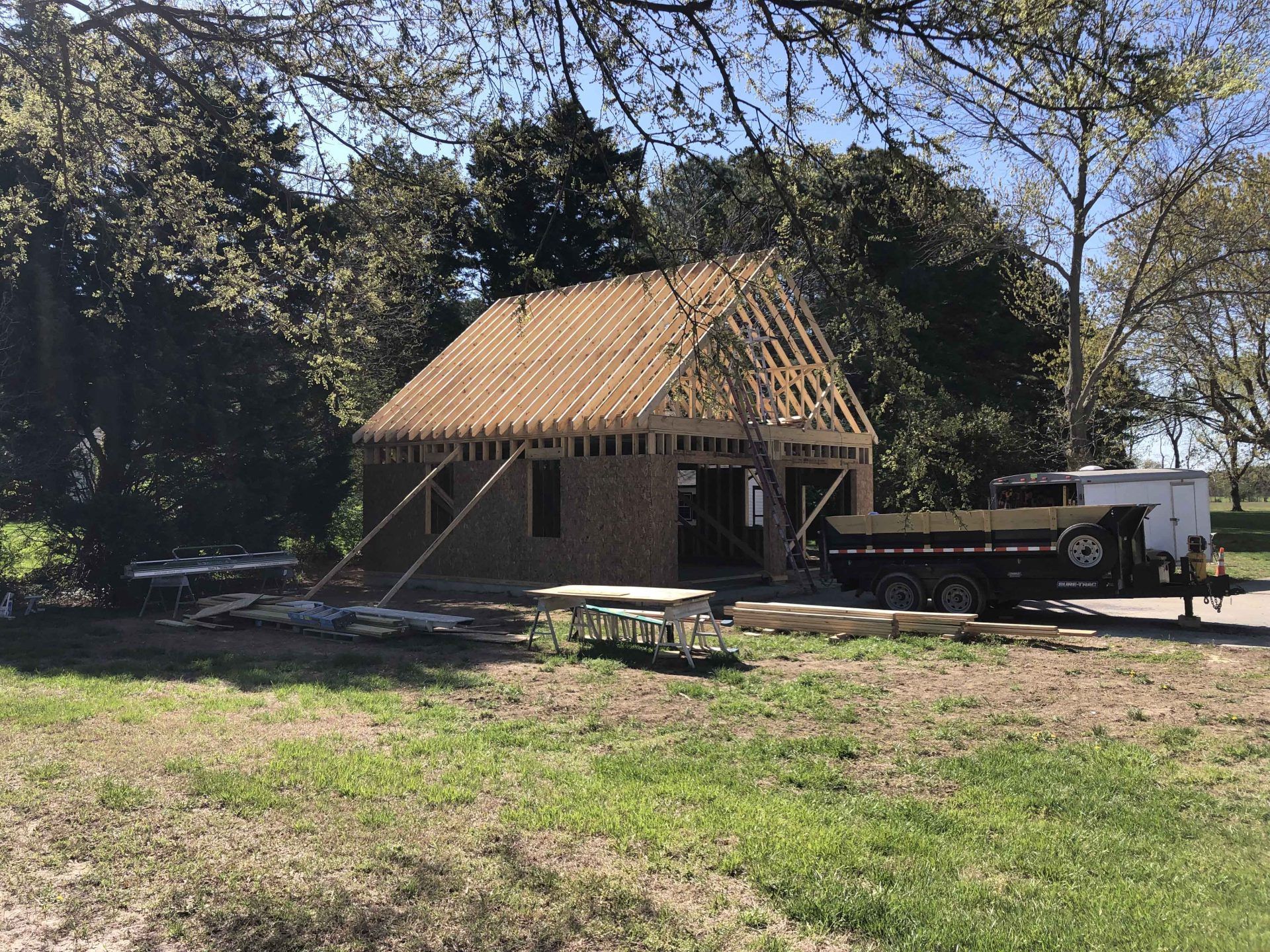 A truck is parked in front of a house under construction.
