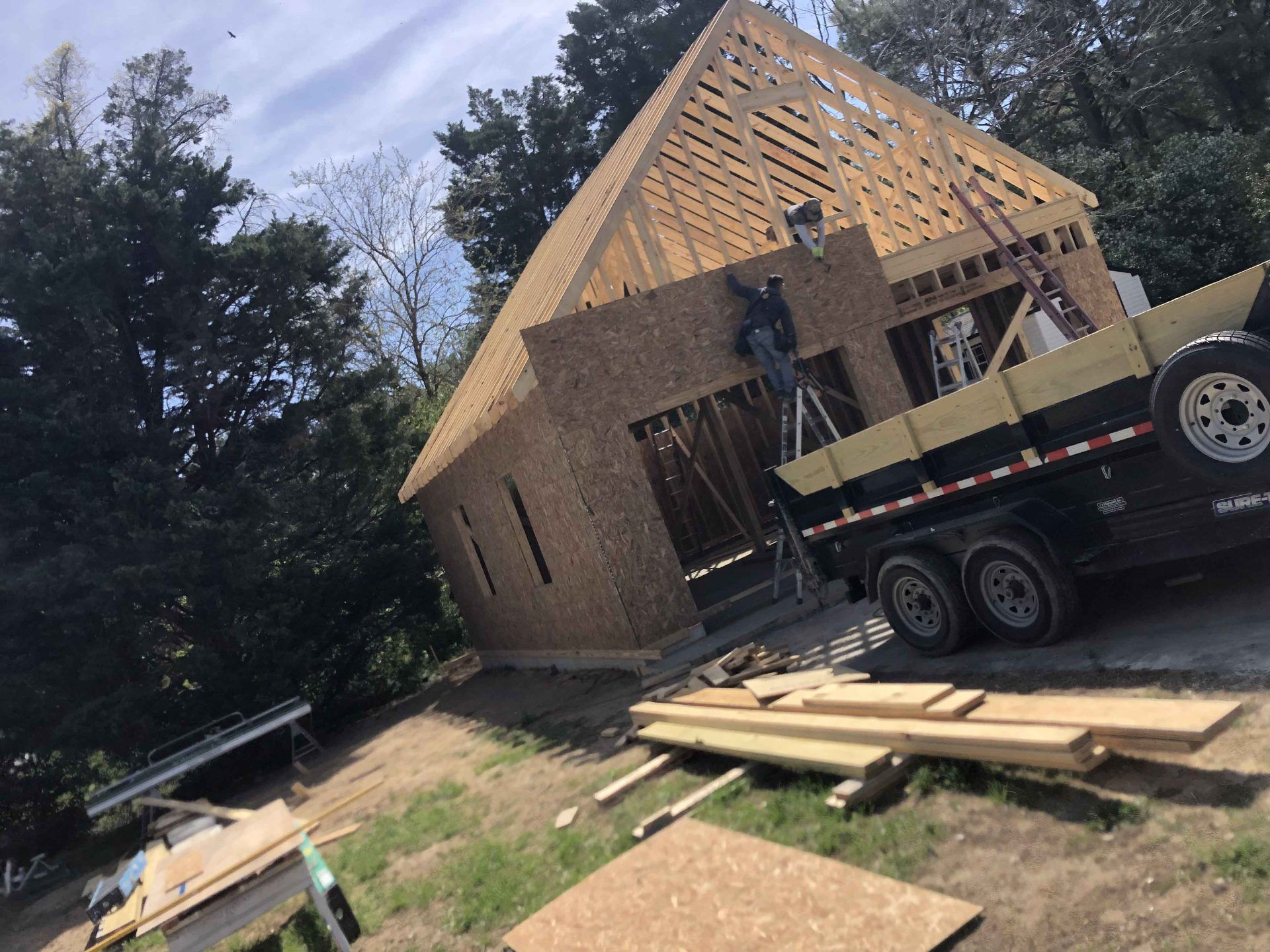 A truck is parked in front of a house under construction.