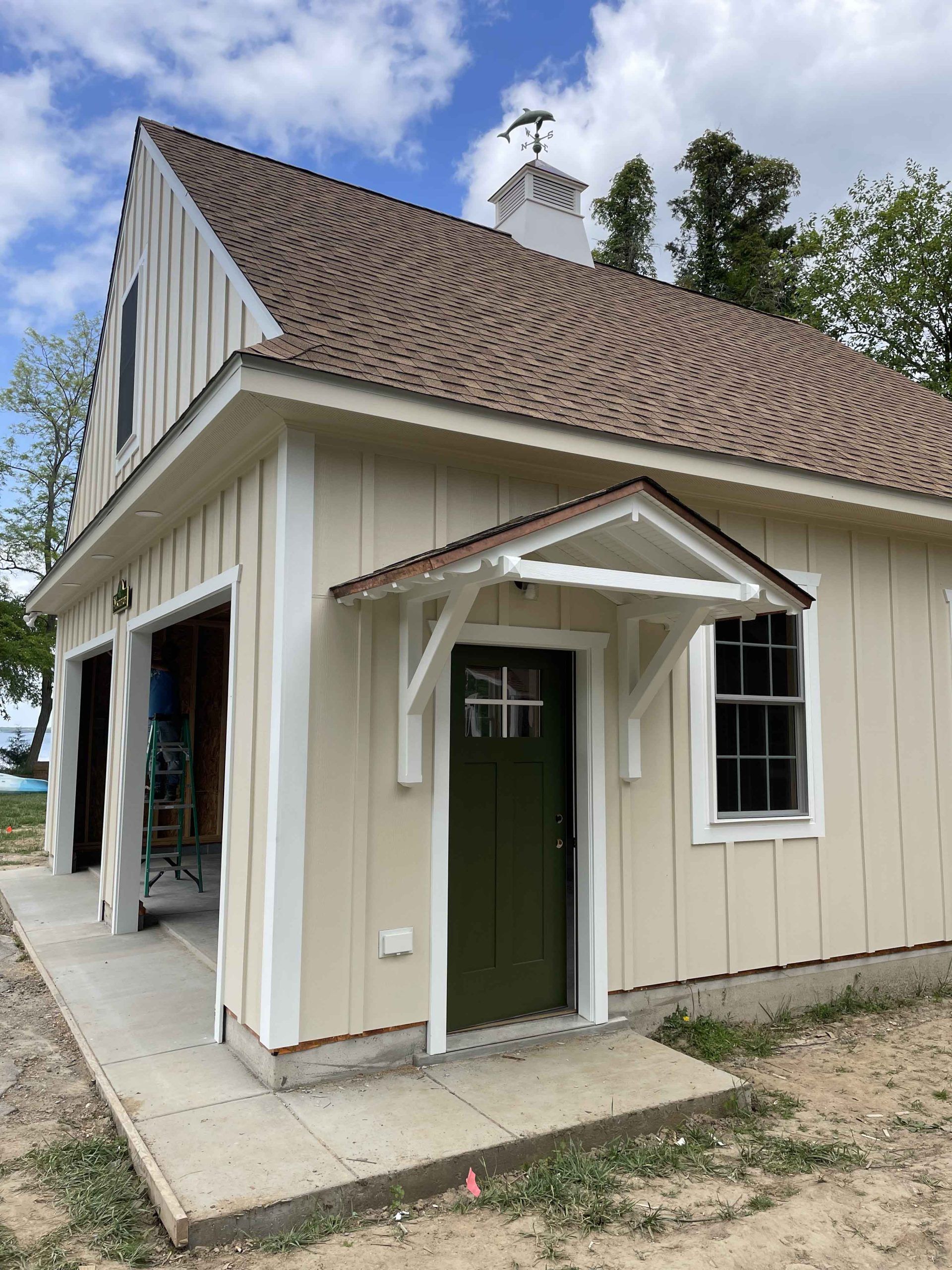A small house with a brown roof and a green door
