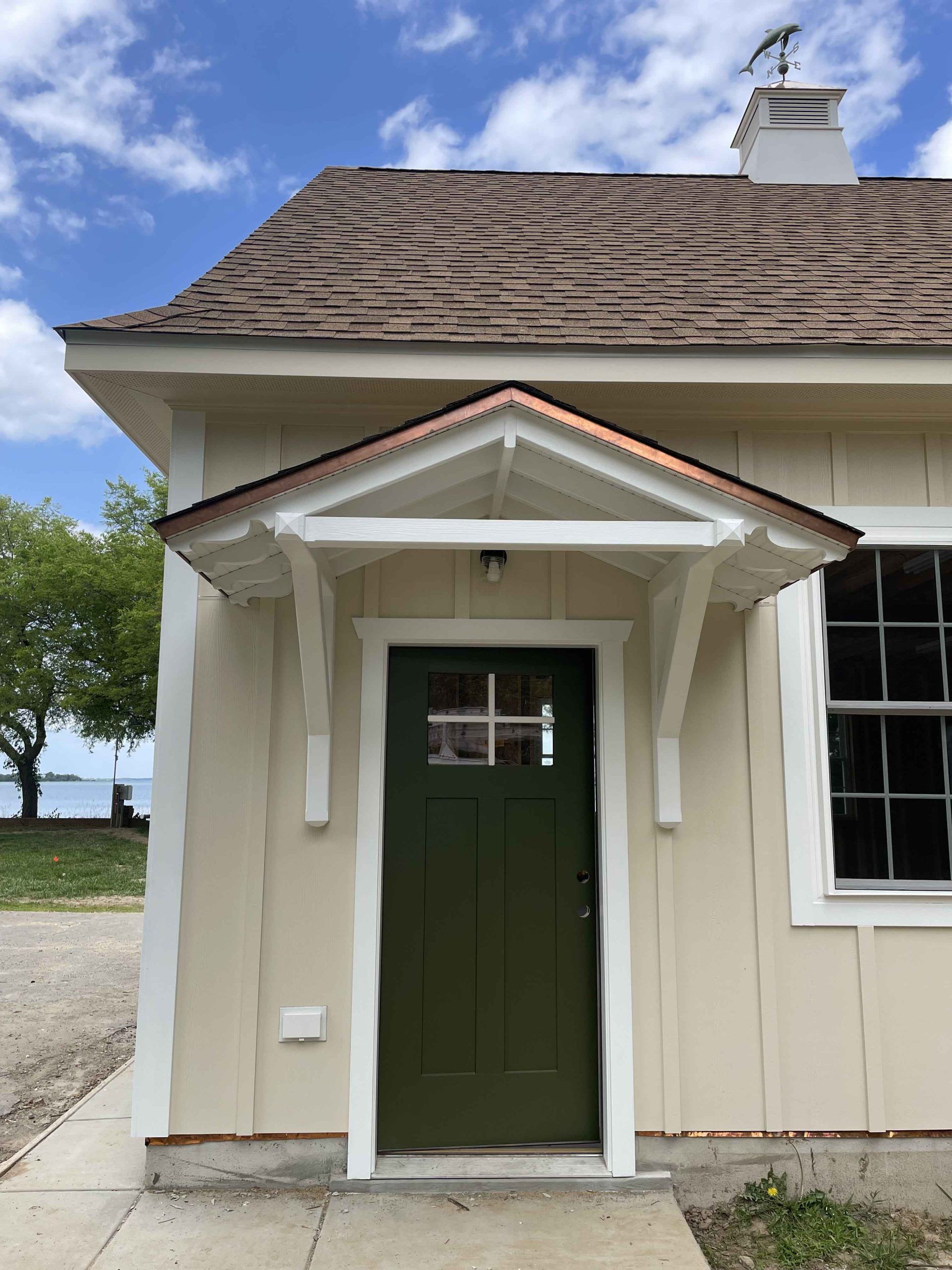 A house with a green door and a copper roof