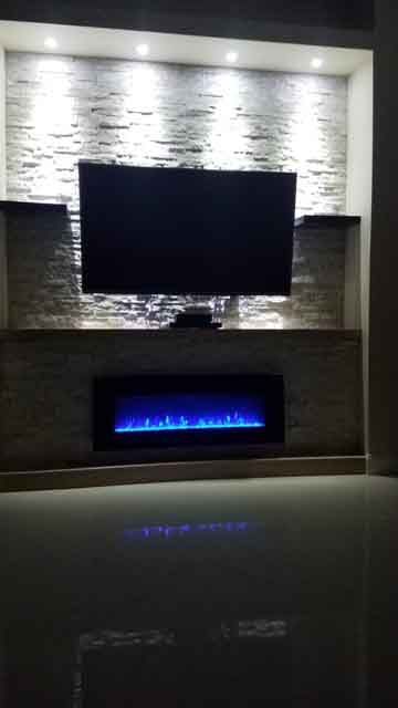 A living room with a fireplace and a flat screen tv.