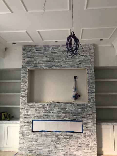 There is a fireplace in the middle of the room.