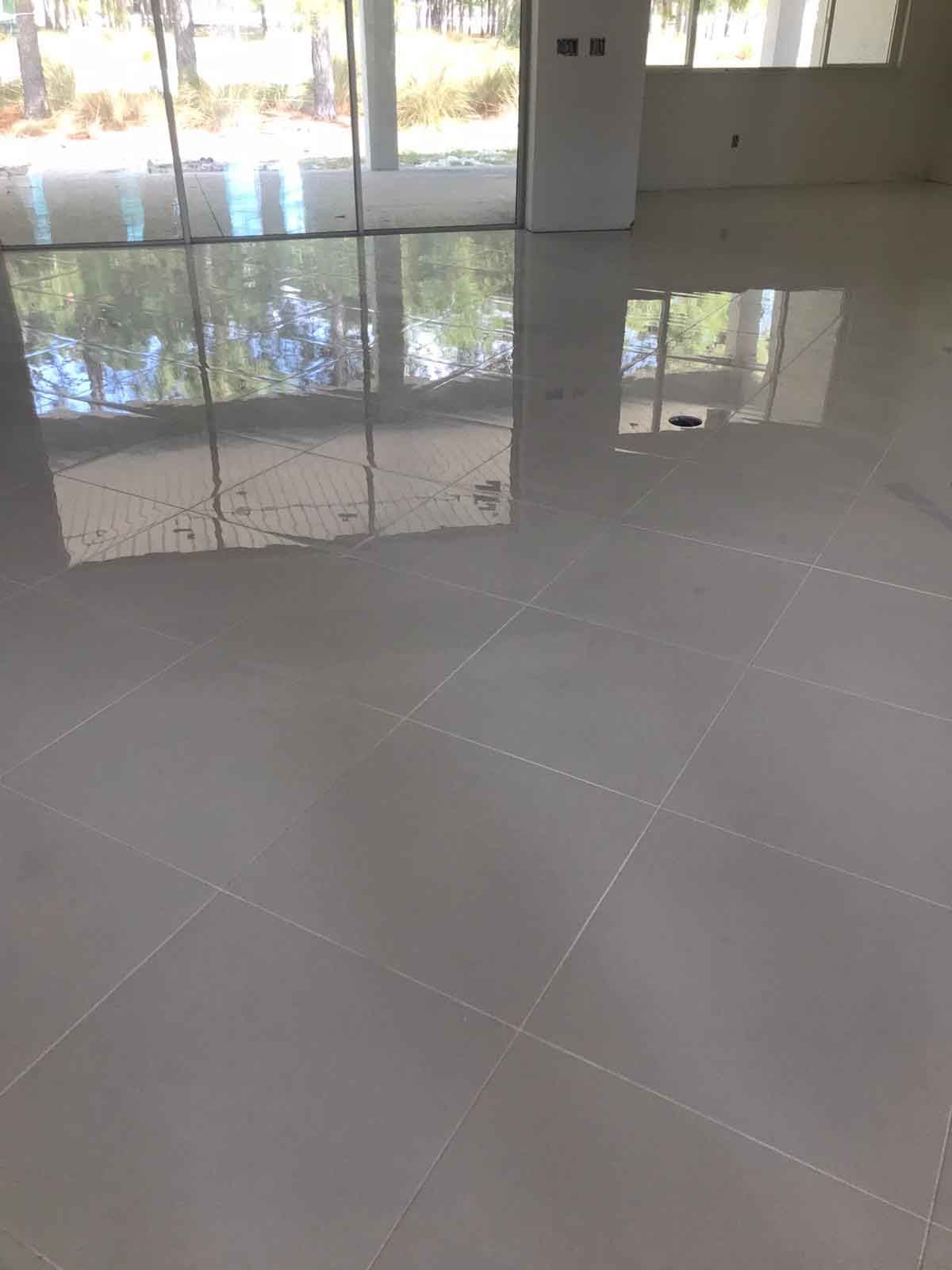 A large room with a tiled floor and sliding glass doors.