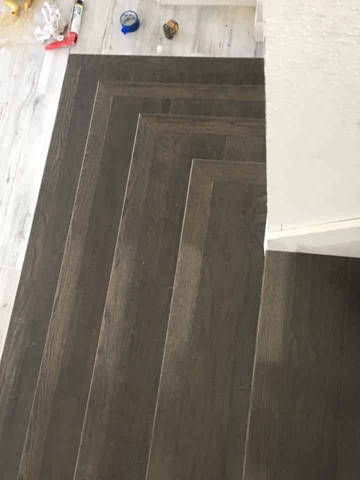 A set of wooden stairs sitting on top of a wooden floor.